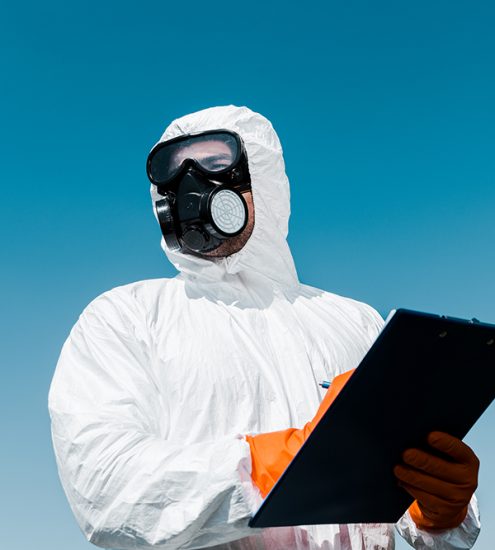 man in protective mask and uniform holding clipboard man in protective mask and uniform holding clipboard